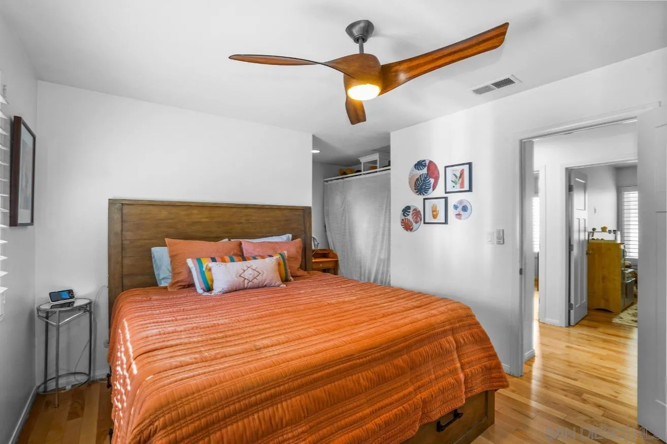 1161 Balour Drive Encinitas, CA 92024 - Photo 17 of 48 a bedroom with a bed and a chandelier