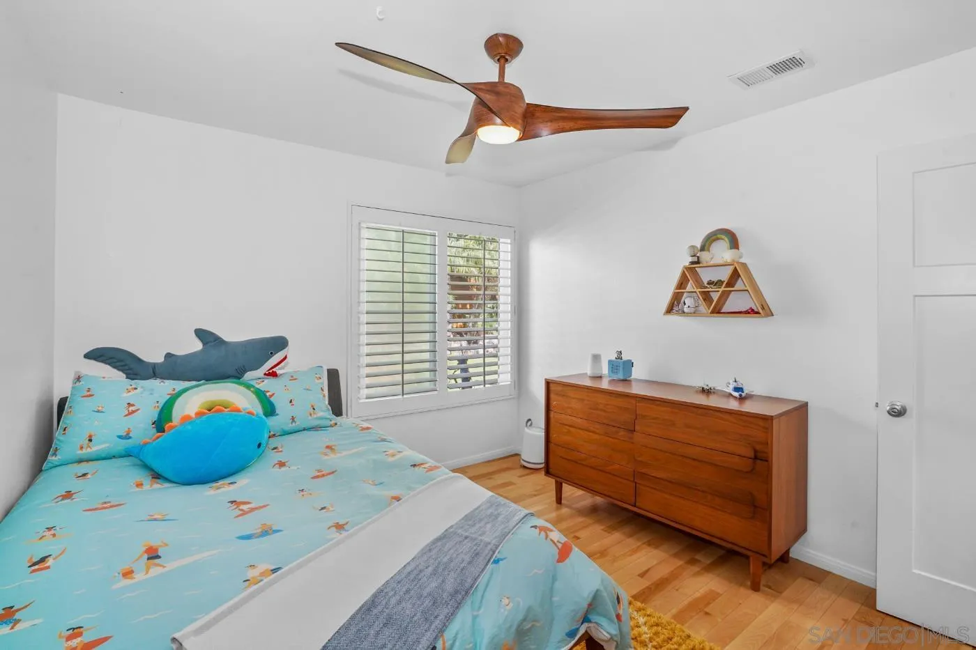 1161 Balour Drive Encinitas, CA 92024 - Photo 25 of 48 a bedroom with a bed and a chandelier