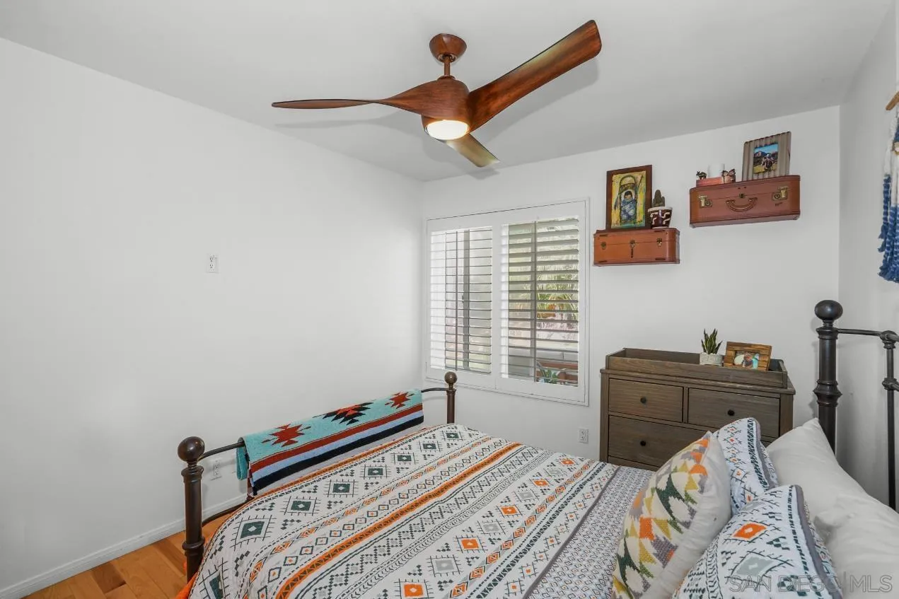 1161 Balour Drive Encinitas, CA 92024 - Photo 27 of 48 a bedroom with a bed and wooden floor