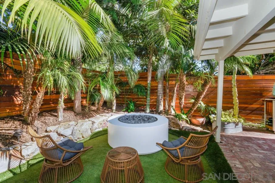 1161 Balour Drive Encinitas, CA 92024 - Photo 42 of 48 a view of a patio with table and chairs potted plants and palm tree