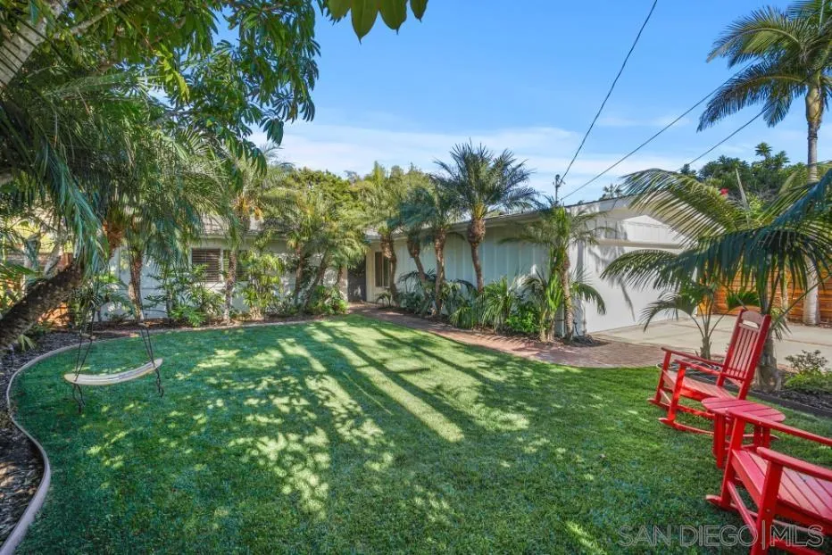 1161 Balour Drive Encinitas, CA 92024 - Photo 44 of 48 a backyard of a house with table and chairs plants and swimming pool