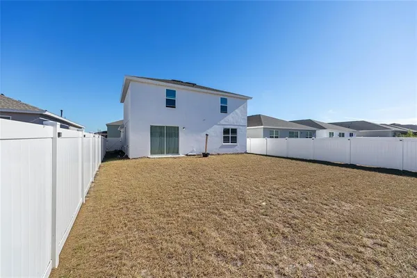 an empty room with a empty space and windows