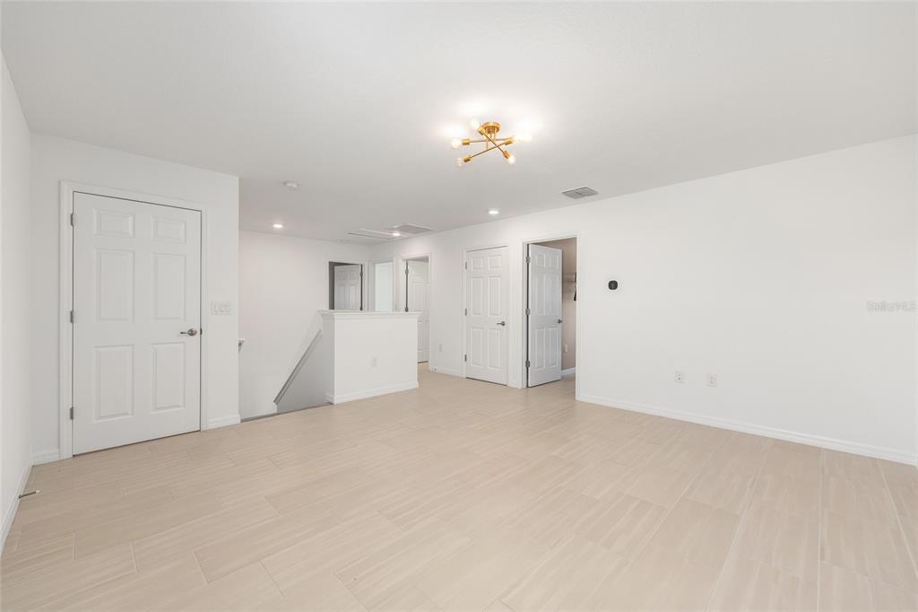 6366 Southwest 77th Avenue Ocala, FL 34474 - Photo 17 of 65 an empty room with a bathroom