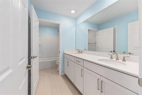 an empty room with closet and windows