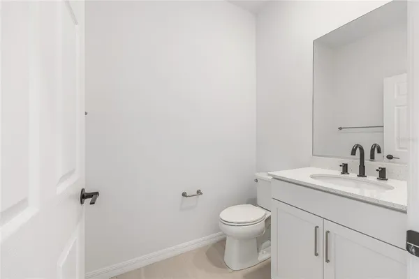 an empty room with windows and fireplace