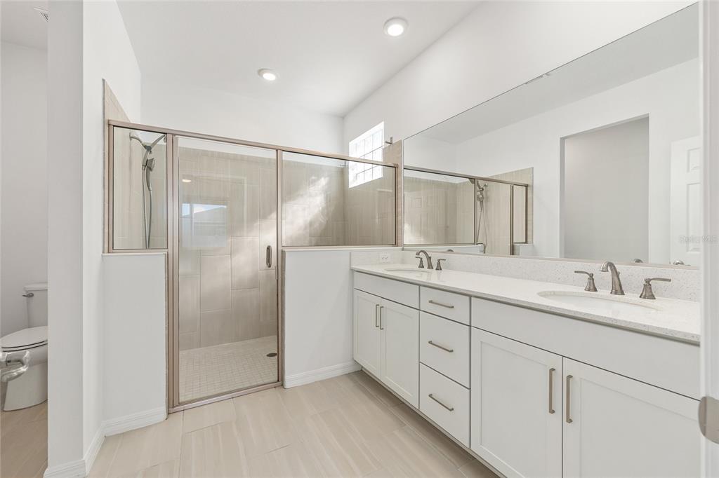 6366 Southwest 77th Avenue Ocala, FL 34474 - Photo 29 of 65 a bathroom with a double vanity sink mirror and shower