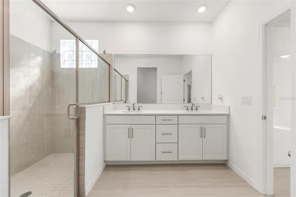 a kitchen with kitchen island a sink stainless steel appliances and a chandelier
