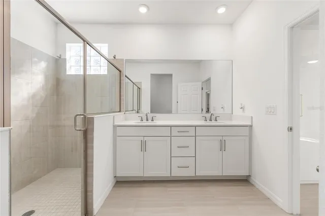 a kitchen with kitchen island a sink stainless steel appliances and a chandelier
