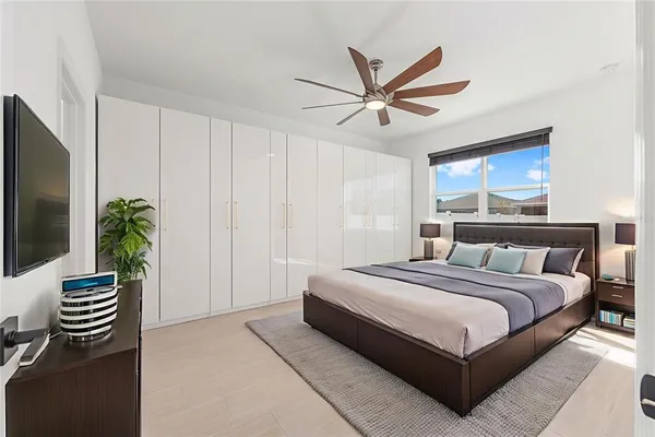 a bedroom with a bed and a chandelier