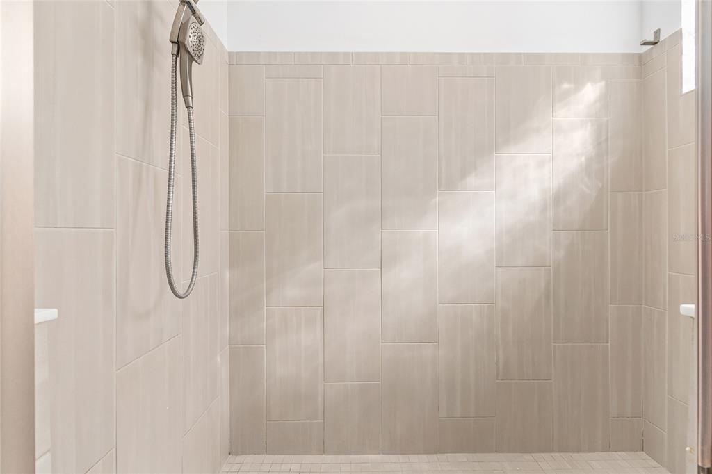 6366 Southwest 77th Avenue Ocala, FL 34474 - Photo 31 of 65 a bathroom with a glass shower door