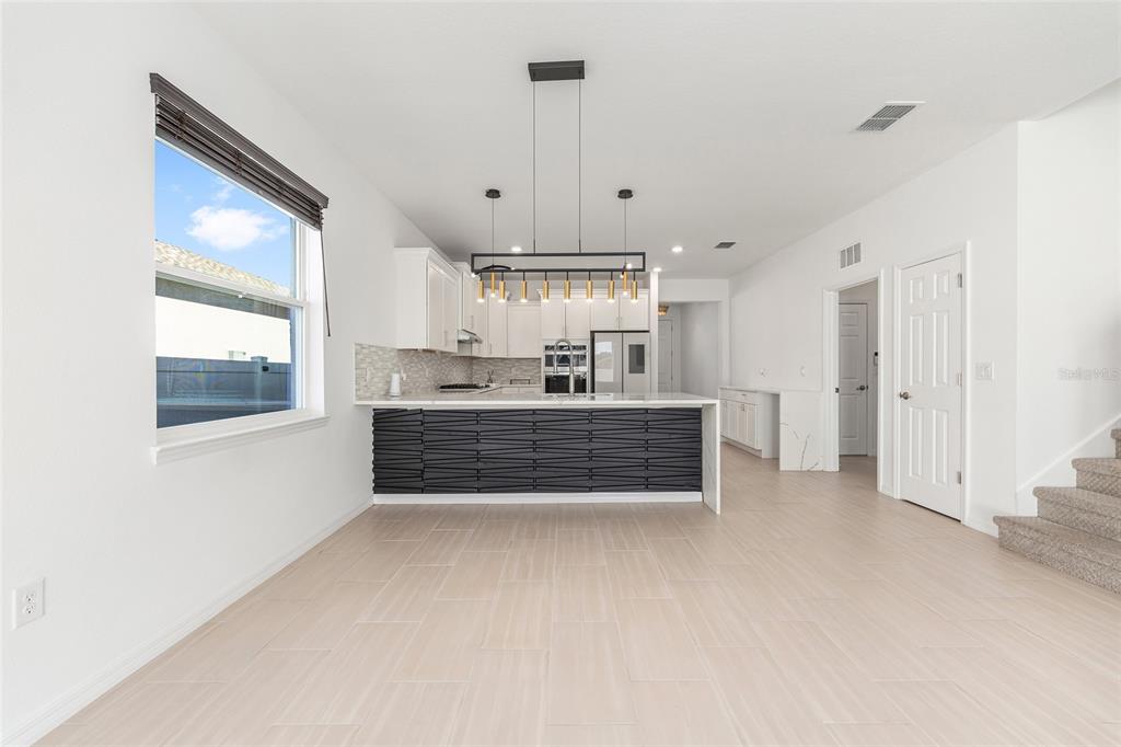 6366 Southwest 77th Avenue Ocala, FL 34474 - Photo 33 of 65 a living room with kitchen island granite countertop furniture and a fireplace