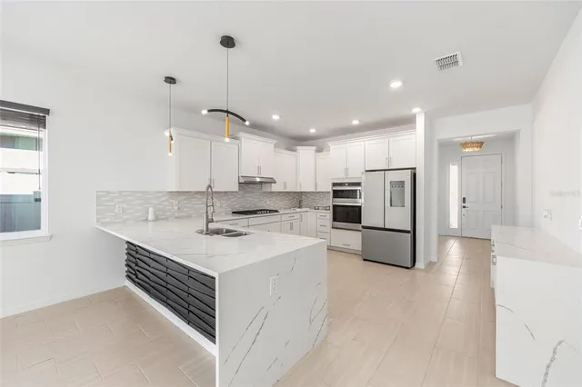 an aerial view of residential houses with outdoor space and river