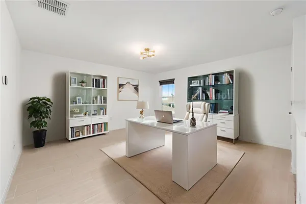a living room with furniture and entryway