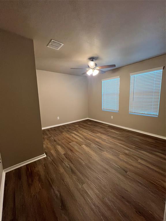 1515 Fields View Drive Anna, TX 75409 - Photo 11 of 16 an empty room with wooden floor chandelier fan and windows