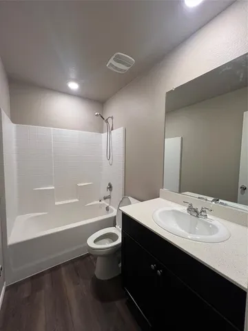 a bathroom with a double vanity sink toilet mirror and bathtub