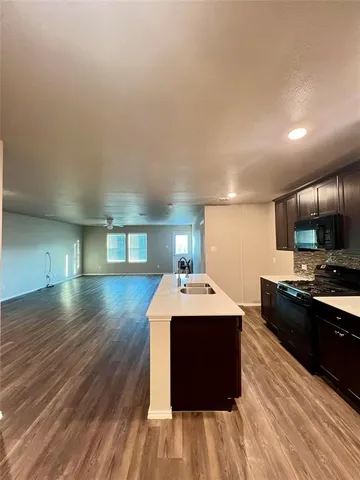 a kitchen with a sink and a stove top oven