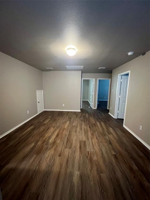 1515 Fields View Drive Anna, TX 75409 - Photo 9 of 16 an empty room with wooden floor and windows