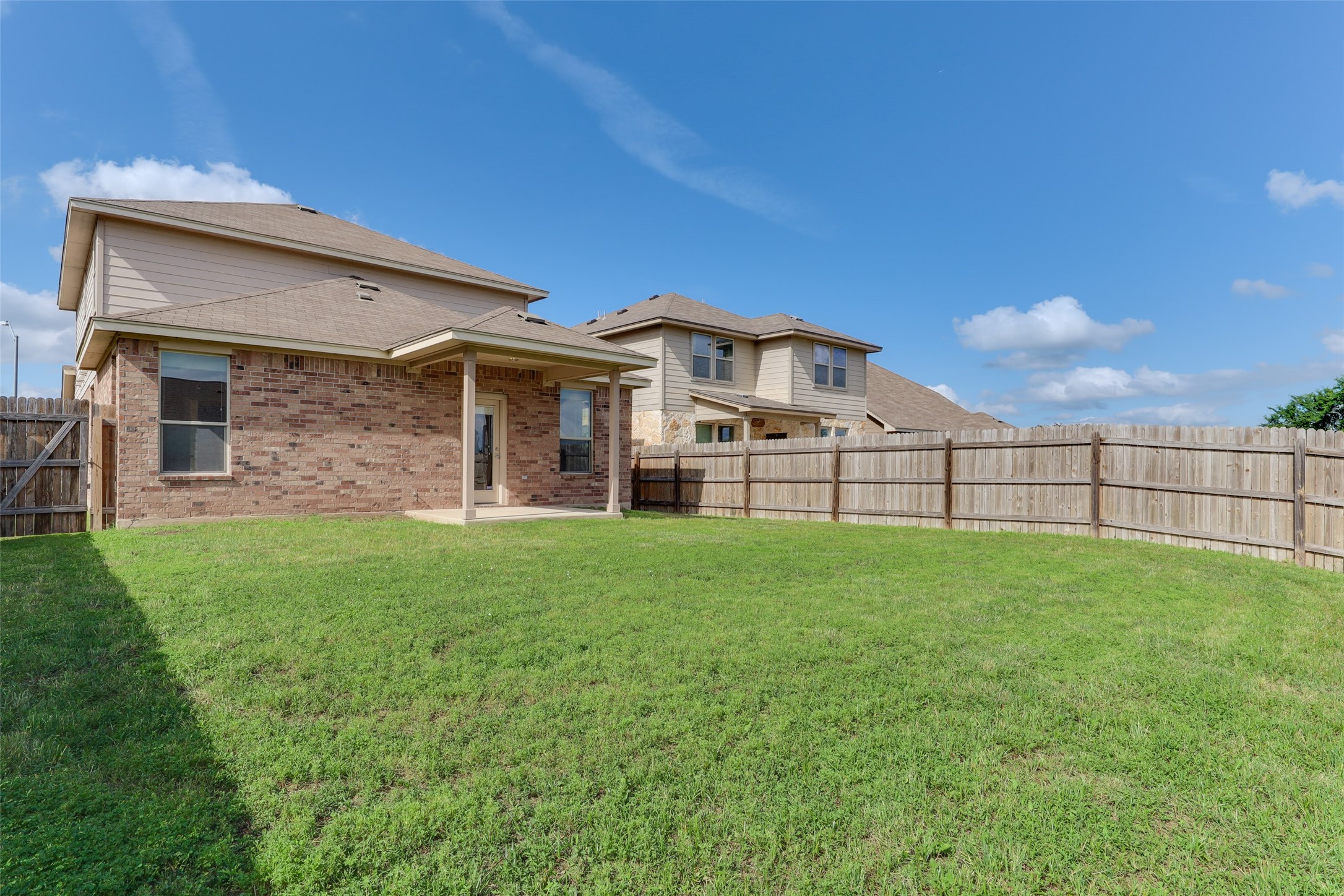 18705 Moreto Loop Pflugerville, TX 78660 - Photo 21 of 21 A spacious backyard with a private wooden fence offers ample room for outdoor activities.