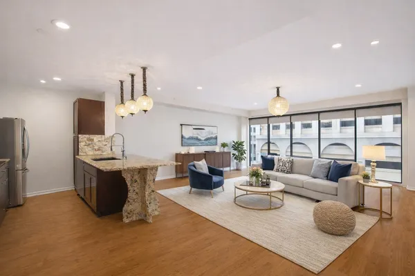 a kitchen with kitchen island granite countertop wooden cabinets and granite counter tops