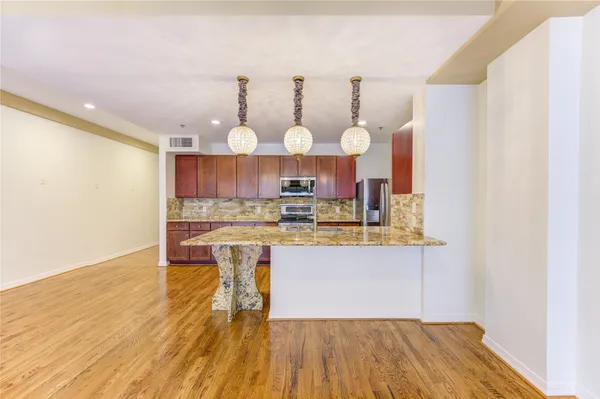 a kitchen with stainless steel appliances granite countertop a sink and stove