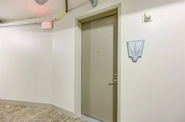 a living room with fireplace furniture and a view of kitchen