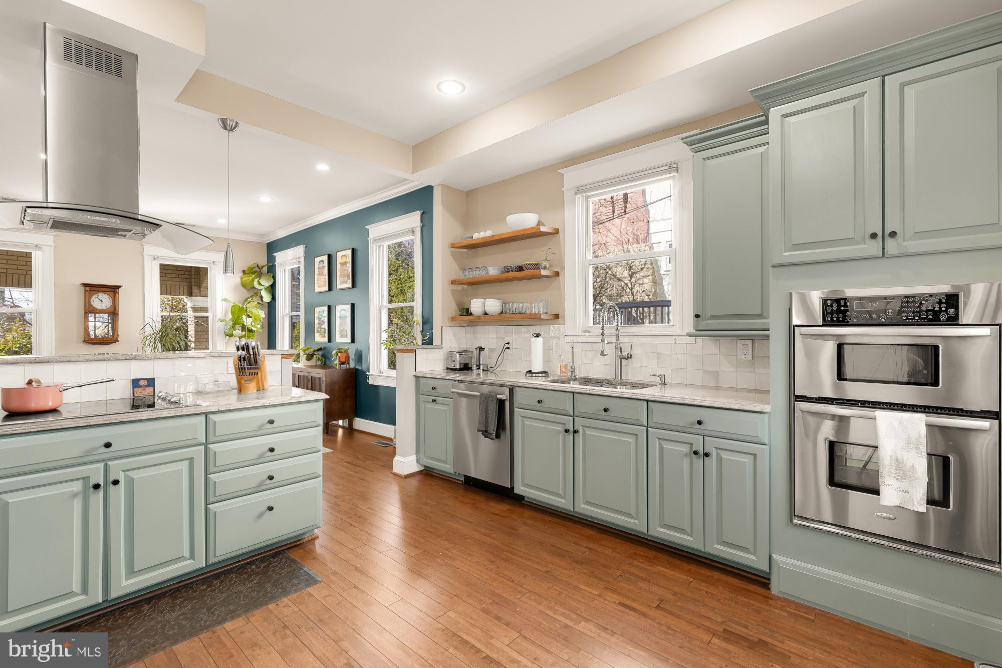 1409 Decatur Street Northwest Washington, DC 20011 - Photo 14 of 42 a large kitchen with stainless steel appliances granite countertop a lot of counter space and wooden floors
