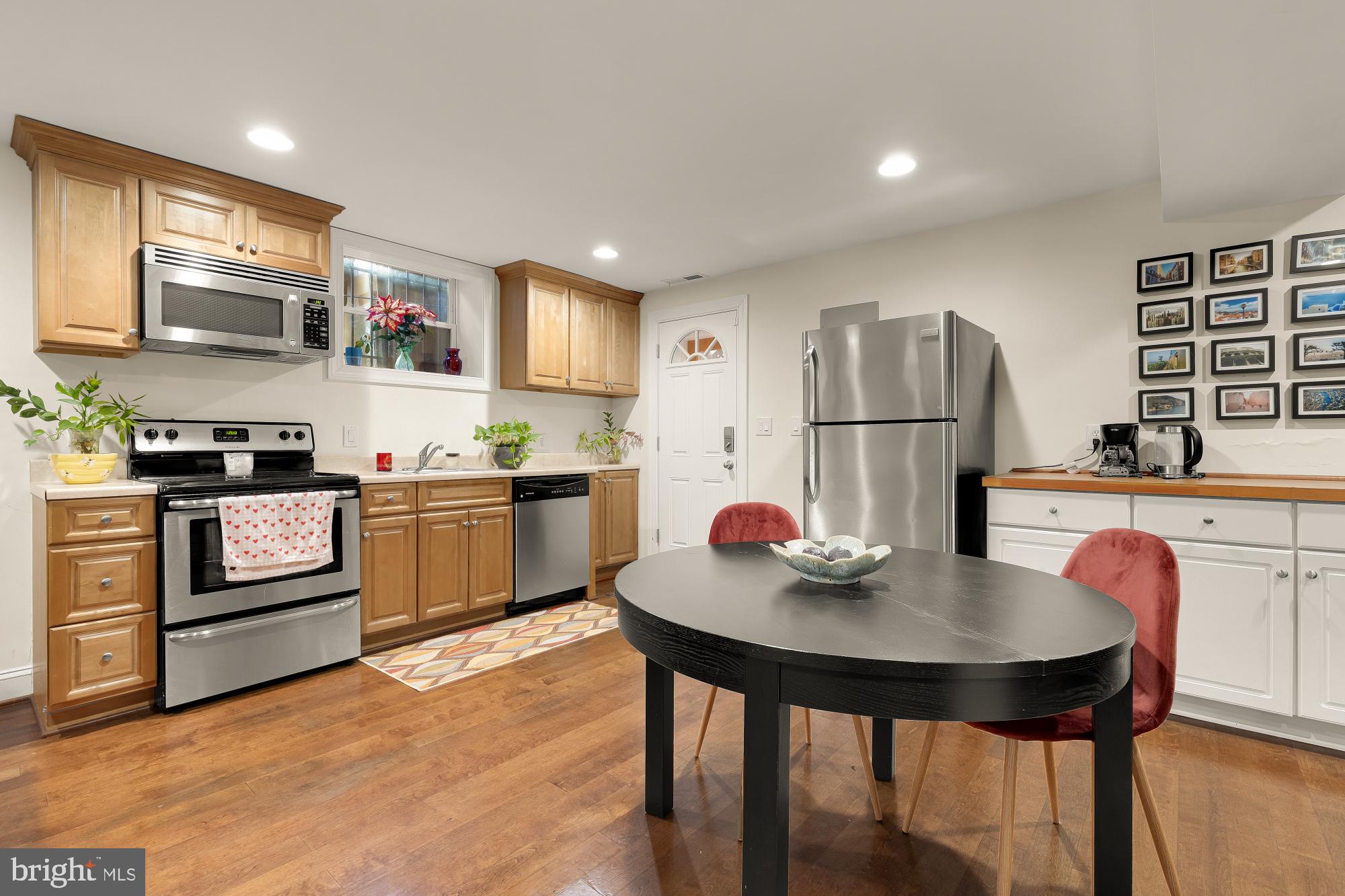 1409 Decatur Street Northwest Washington, DC 20011 - Photo 32 of 42 a kitchen with a sink a kitchen island and stainless steel appliances