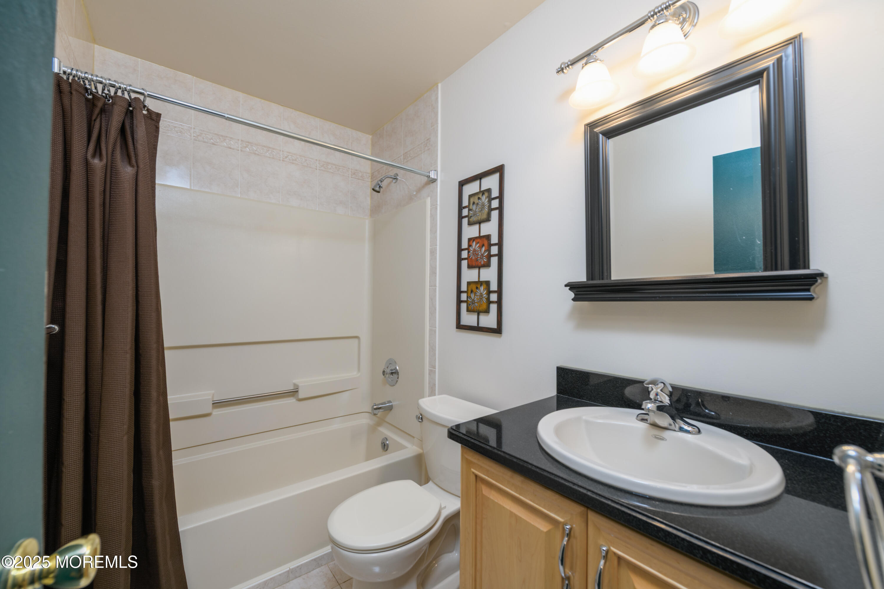 85 Starlight Road Howell, NJ 07731 - Photo 12 of 37 a bathroom with a granite countertop sink toilet a mirror a vanity and shower