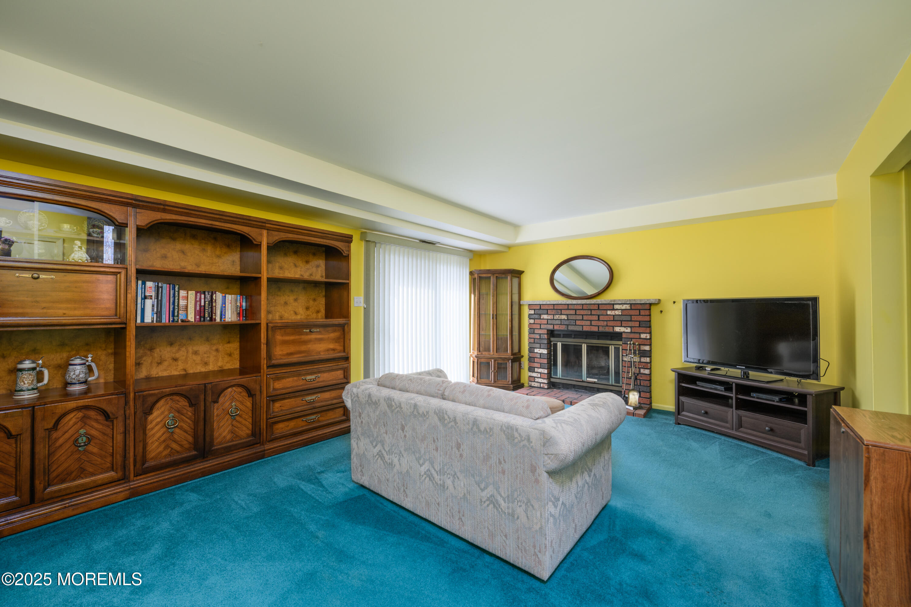 85 Starlight Road Howell, NJ 07731 - Photo 14 of 37 a living room with fireplace furniture and a flat screen tv