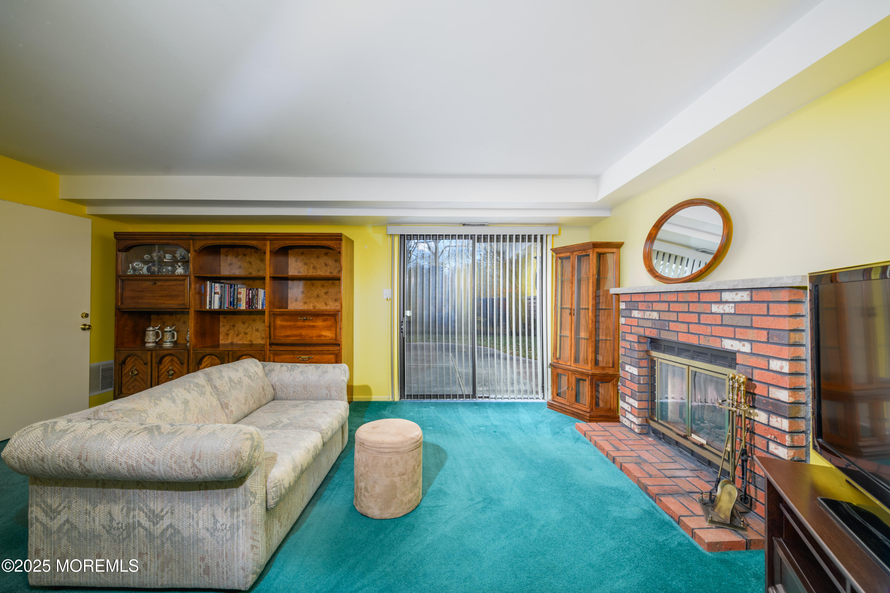 85 Starlight Road Howell, NJ 07731 - Photo 15 of 37 a living room with furniture a flat screen tv and a fireplace