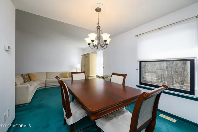 a view of a dining room with furniture and window