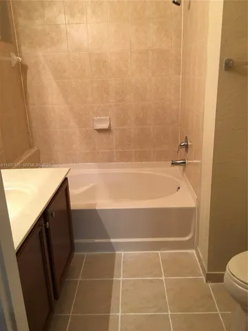 a bathroom with a bathtub and a toilet