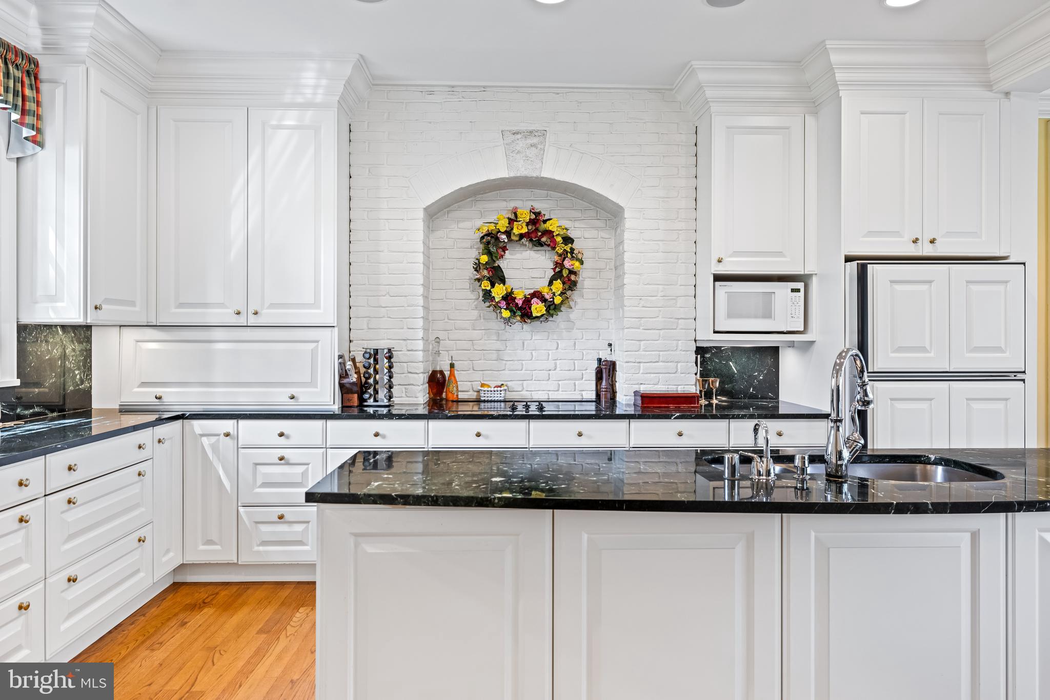 508 Hampton Lane Baltimore, MD 21286 - Photo 17 of 74 a kitchen with granite countertop a sink stainless steel appliances and cabinets