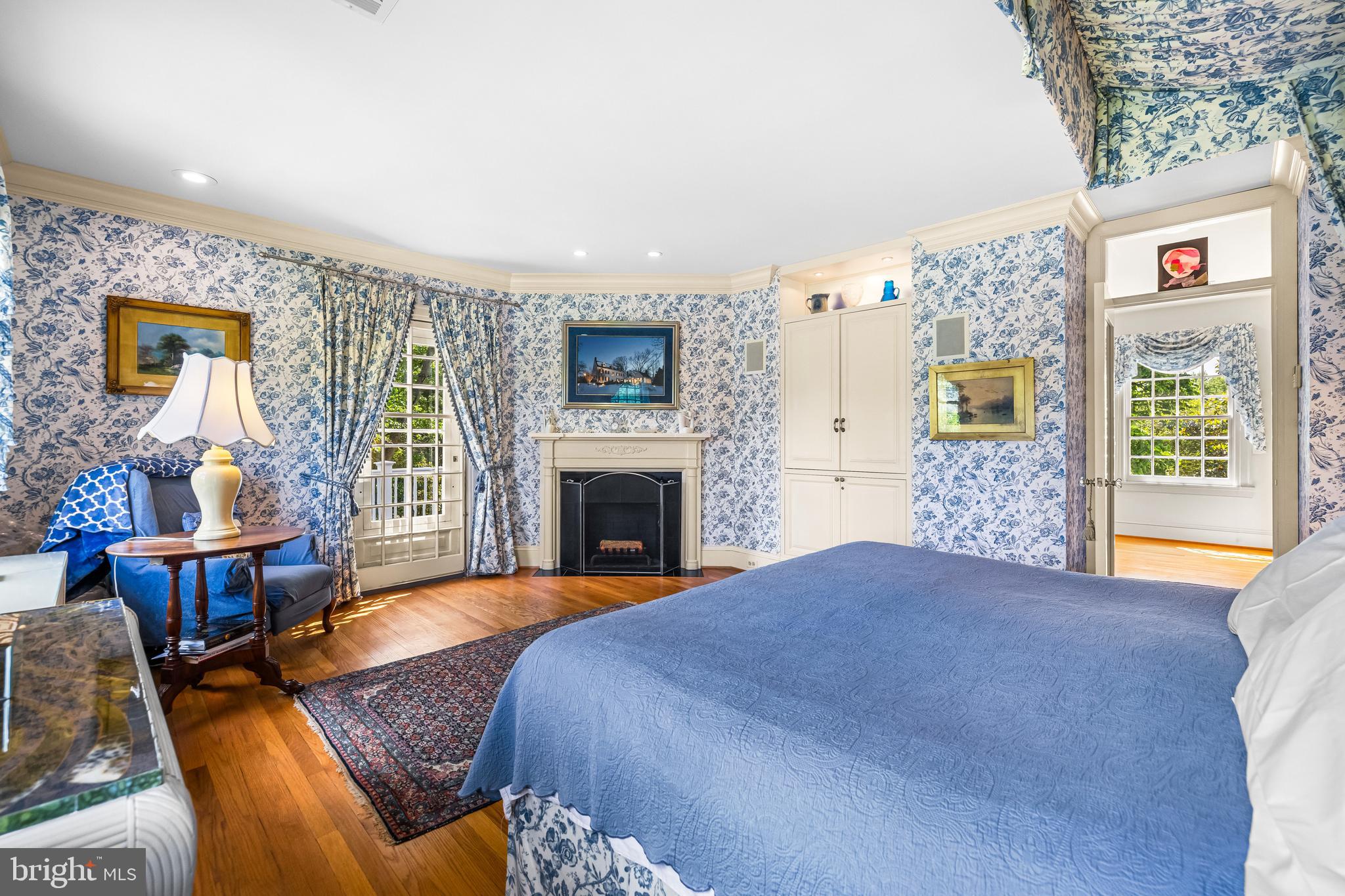 508 Hampton Lane Baltimore, MD 21286 - Photo 37 of 74 a spacious bedroom with a bed and a fireplace