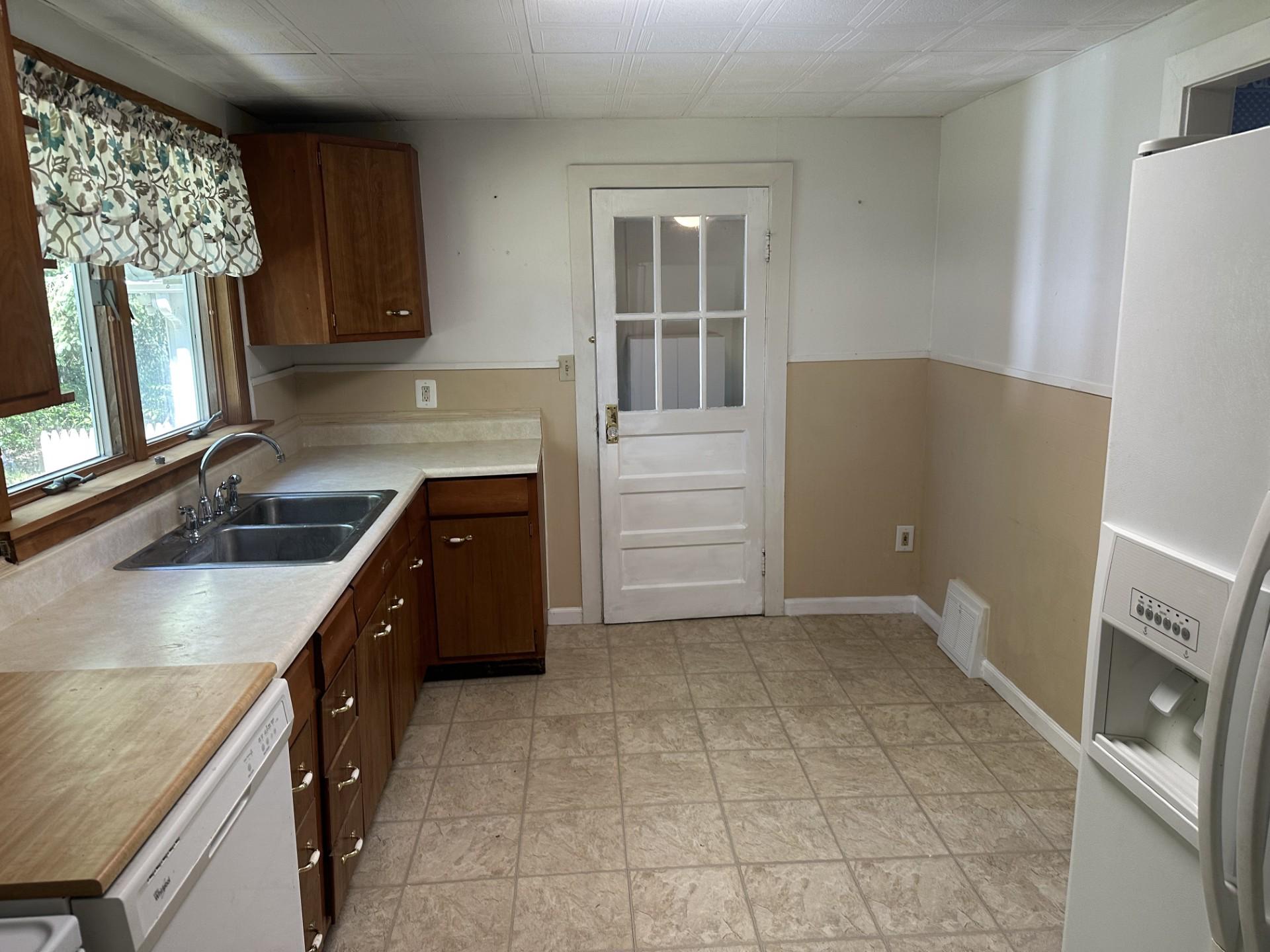 317 Magnolia Road Pemberton, NJ 08068 - Photo 11 of 42 a kitchen with granite countertop a sink a stove a refrigerator and a window