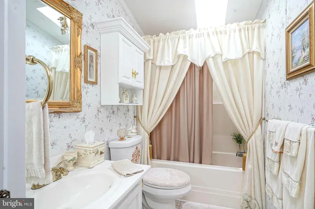 a bathroom with a toilet sink and tub