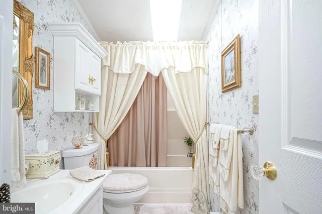 a bathroom with a toilet and a shower curtain