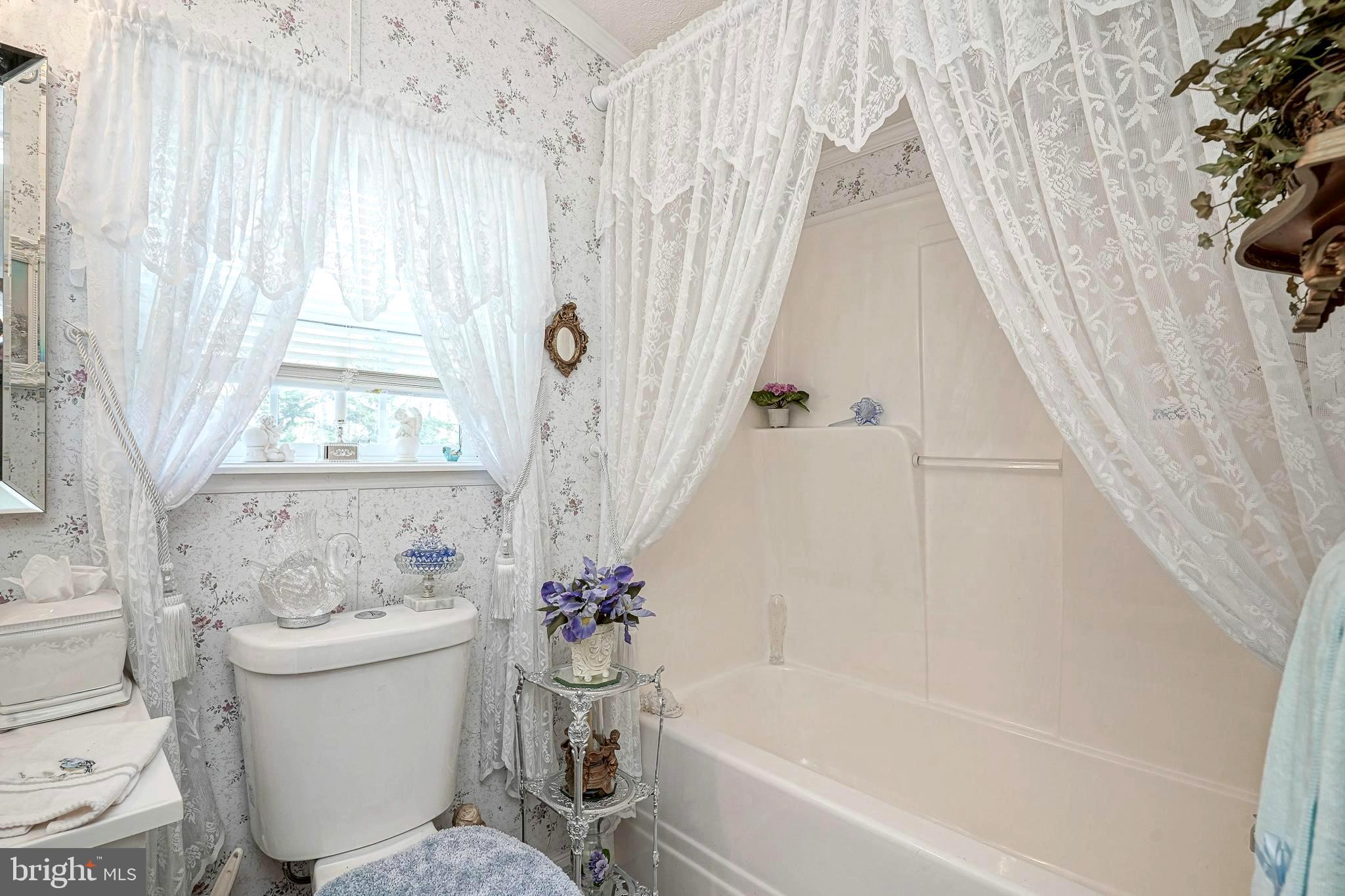 3 Dogwood East Tabernacle, NJ 08088 - Photo 20 of 25 a white bath tub sitting next to a white toilet and curtain