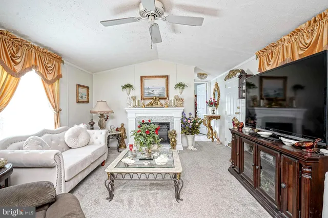 a living room with furniture fireplace and flat screen tv
