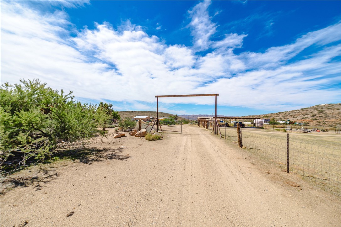 9769 North Rose Quartz Road Chloride, AZ 86431 - Photo 1 of 91 a view of a terrace with lawn chairs and iron fence