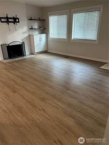 a view of a kitchen with wooden floor and a sink