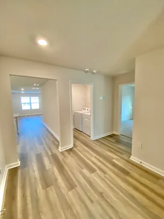 a view of a kitchen with wooden floor and electronic appliances