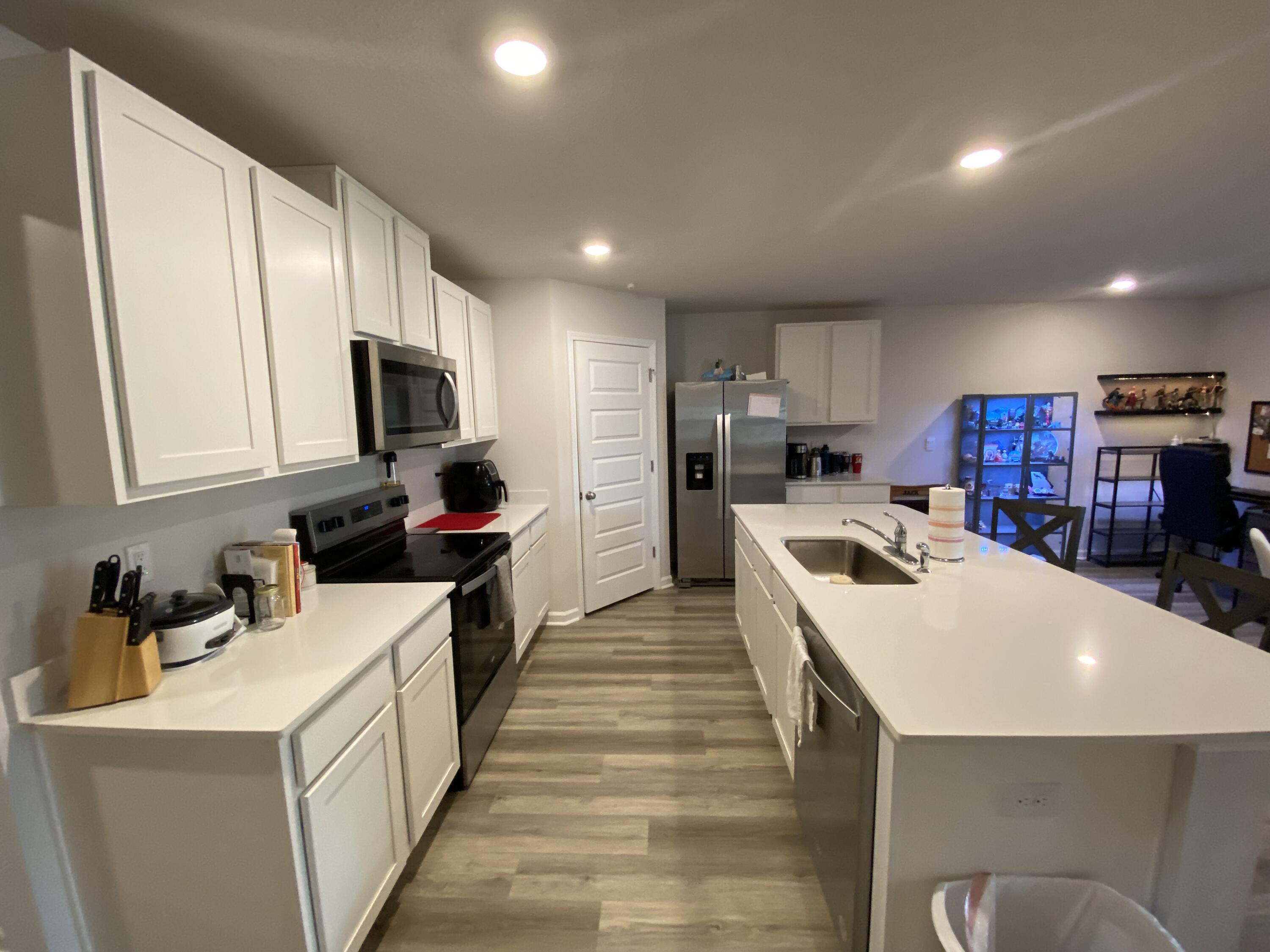 337 Flounder Street Crestview, FL 32539 - Photo 19 of 46 a kitchen that has a lot of cabinets a sink and a stove in it
