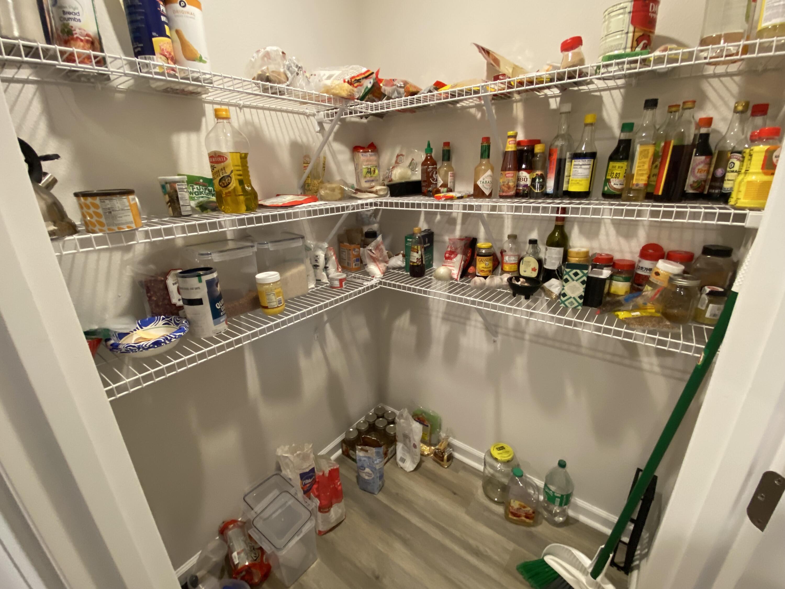 337 Flounder Street Crestview, FL 32539 - Photo 22 of 46 a room with water heater and shelf with wooden floor