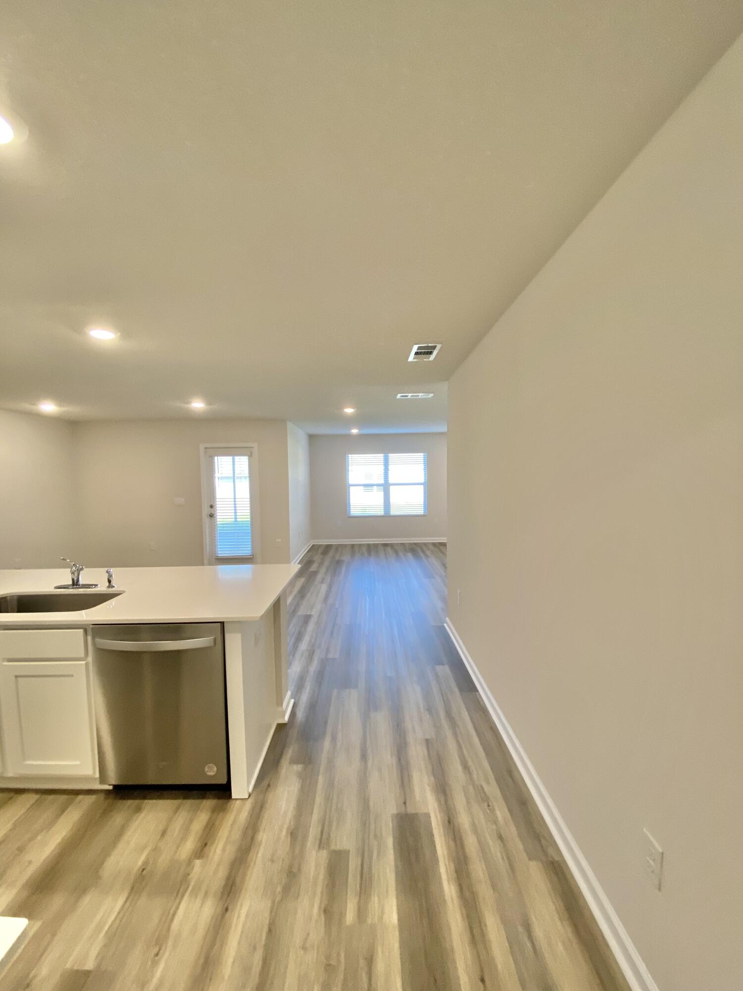 337 Flounder Street Crestview, FL 32539 - Photo 24 of 53 a view of a kitchen with wooden floor and electronic appliances