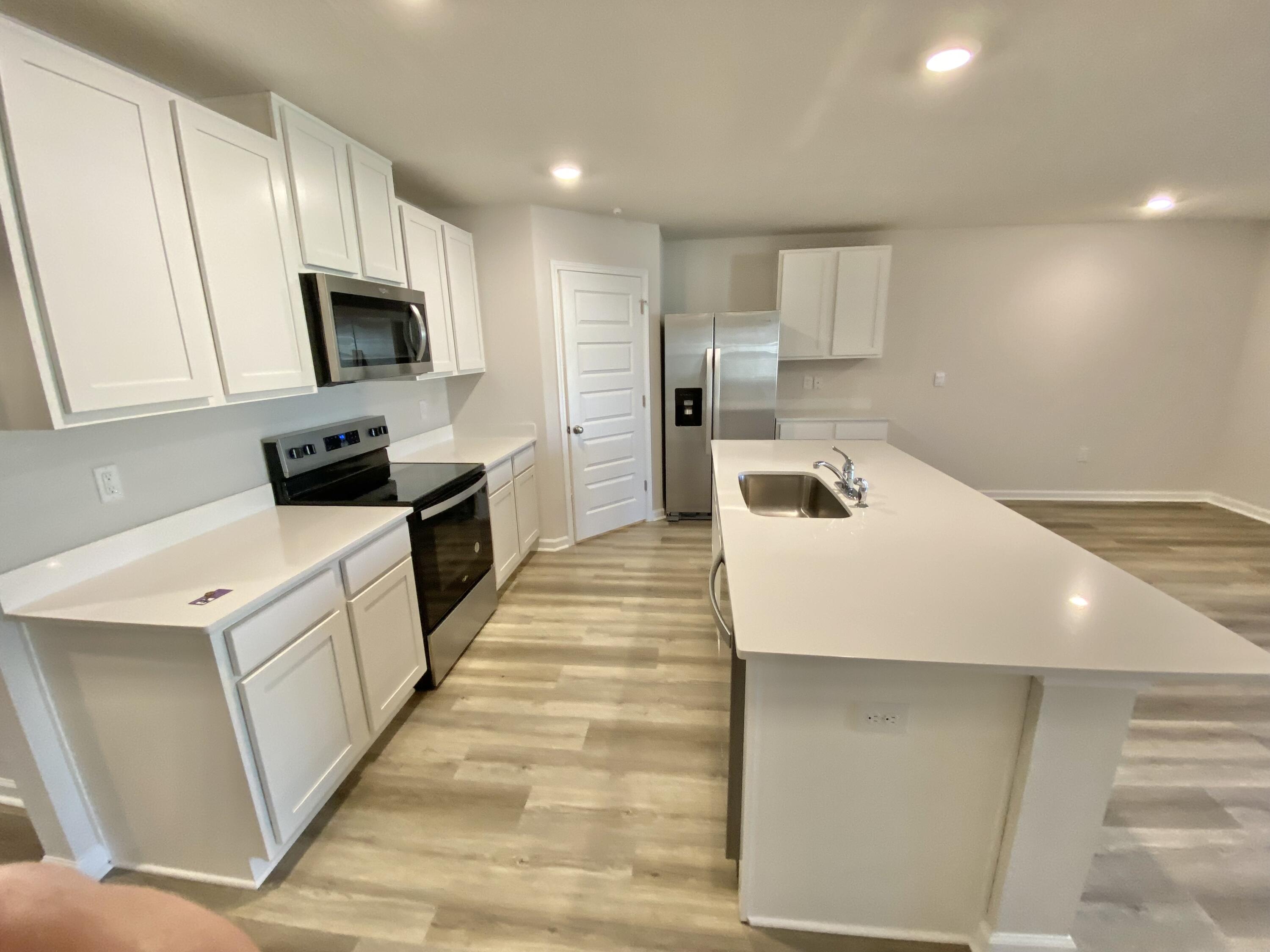 337 Flounder Street Crestview, FL 32539 - Photo 25 of 53 a kitchen with white cabinets and stainless steel appliances