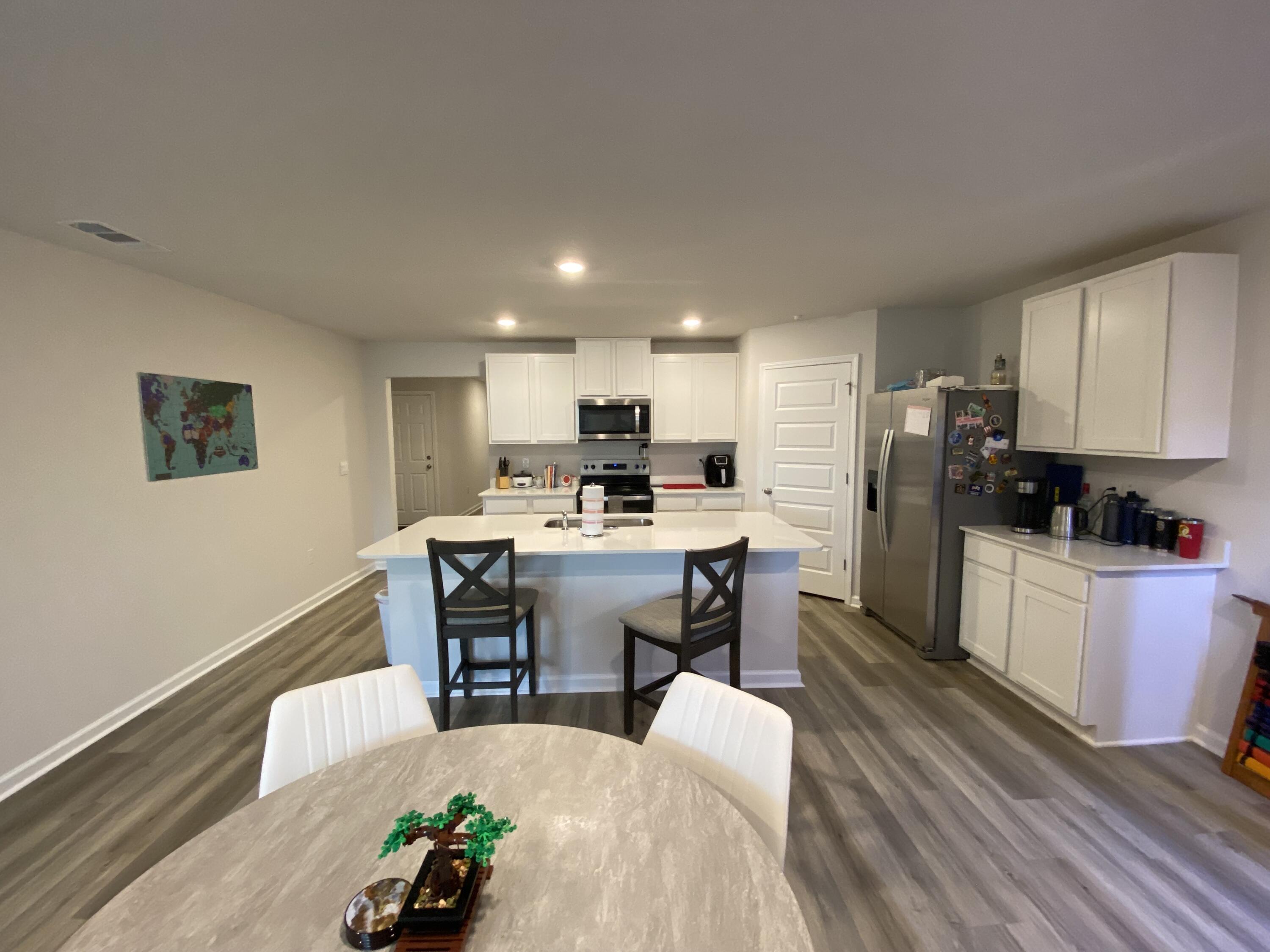 337 Flounder Street Crestview, FL 32539 - Photo 25 of 46 a living room with stainless steel appliances kitchen island granite countertop furniture and a refrigerator