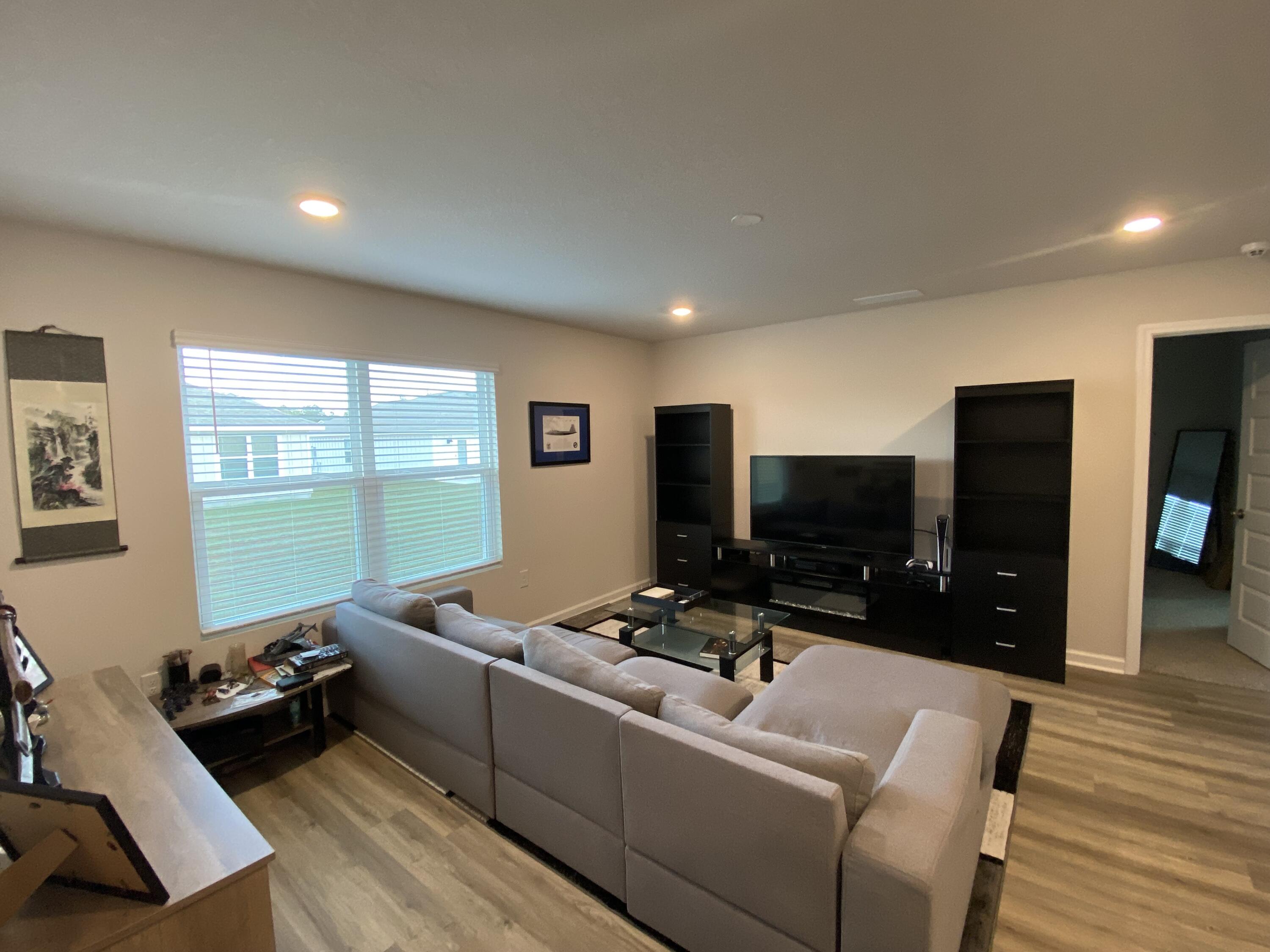 337 Flounder Street Crestview, FL 32539 - Photo 27 of 46 a living room with furniture and a flat screen tv