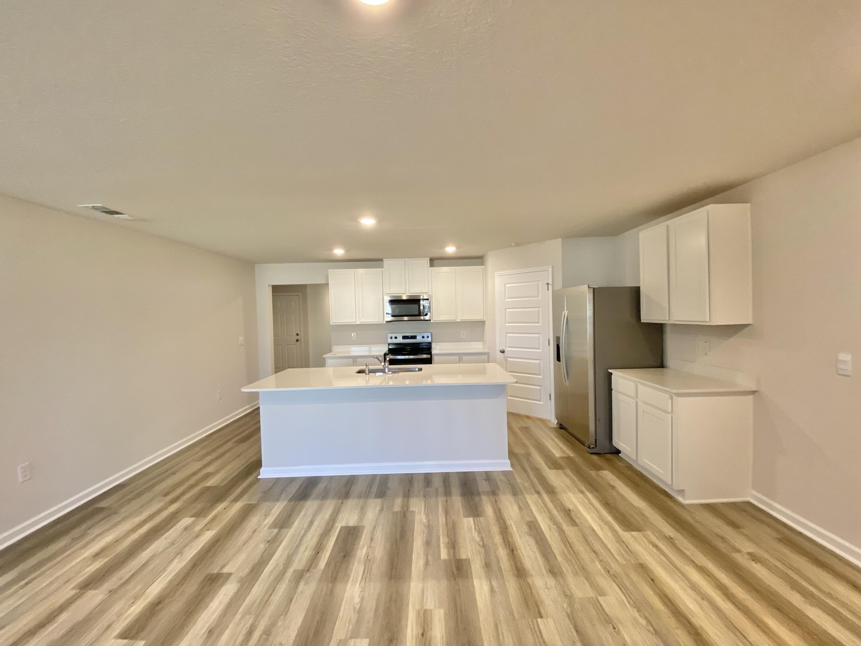 337 Flounder Street Crestview, FL 32539 - Photo 28 of 53 a large kitchen with kitchen island a sink stainless steel appliances and white cabinets