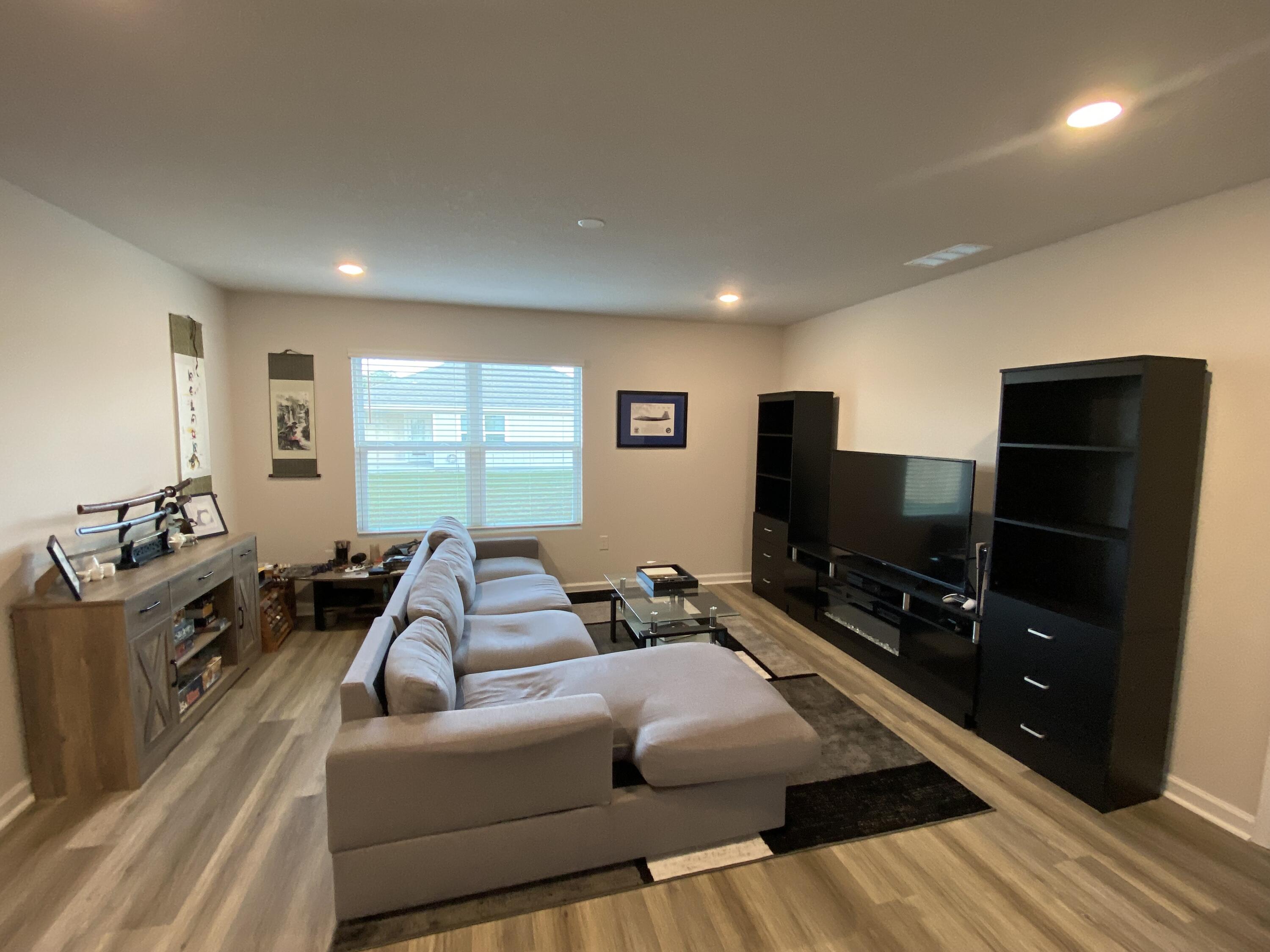 337 Flounder Street Crestview, FL 32539 - Photo 28 of 46 a living room with furniture and a flat screen tv